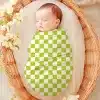 Sleeping Baby Swaddled In A Lime Green And White Checkered Blanket.