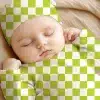 Sleeping Baby Wearing A Lime Green And White Checkered Hat And Outfit.