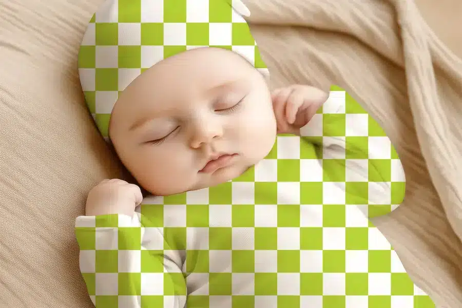 Sleeping Baby Wearing A Lime Green And White Checkered Hat And Outfit.