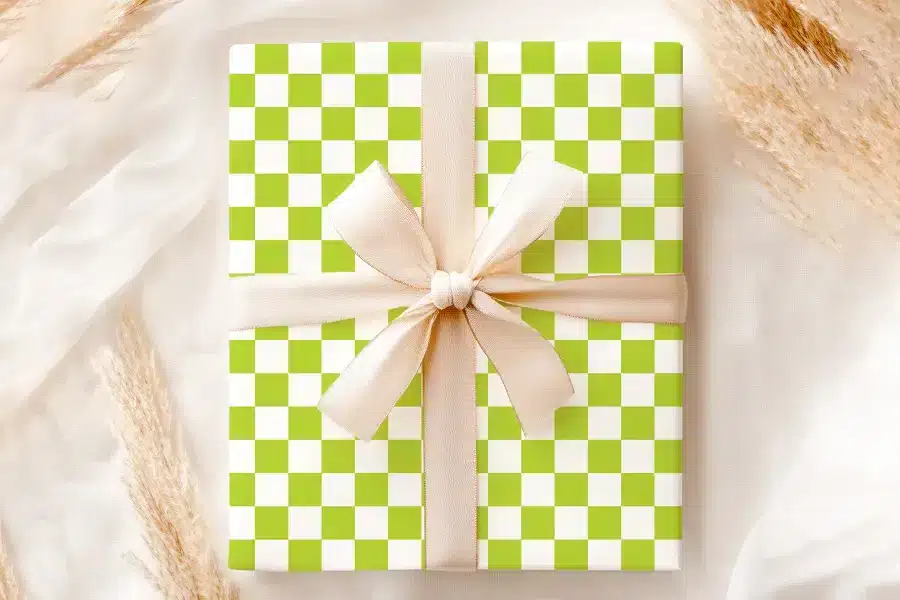 A Lime Green And White Checkered Gift Box With A Beige Ribbon.