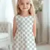 Young Girl Wearing A Sleeveless, Light Gray And White Checkered Dress.