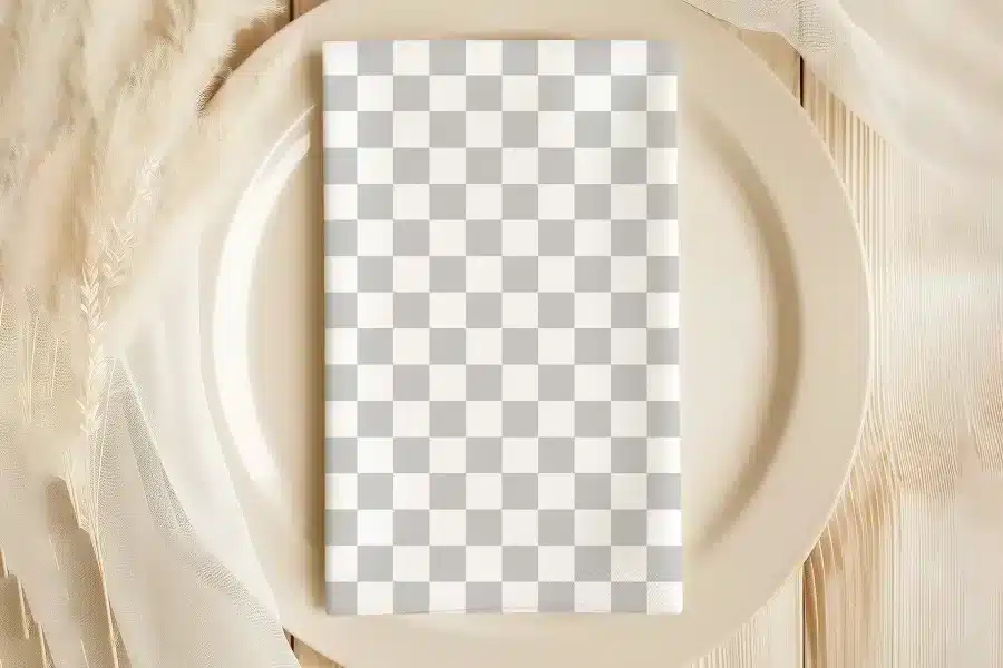 A Beige Plate With A Gray And White Checkered Napkin.