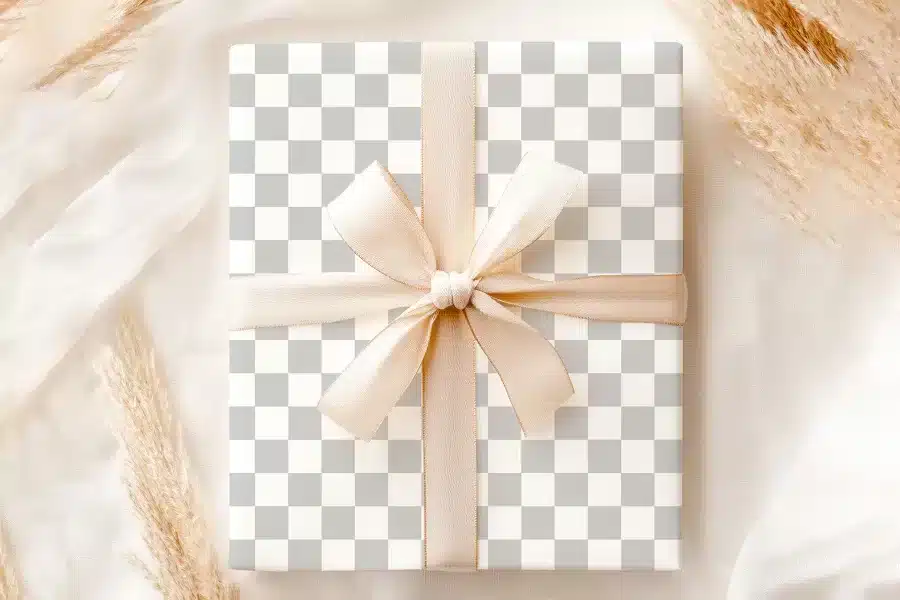 A Gift Box With A Light Beige Ribbon Tied In A Bow.