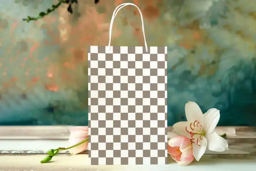 A Brown And White Checkered Paper Shopping Bag With White Handles.