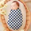 Sleeping Baby Swaddled In A Navy And White Checkered Receiving Blanket.