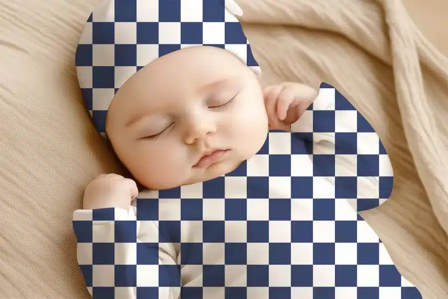Sleeping Baby Wearing A Navy And White Checkered Hat And Outfit.