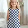 Young Girl In A Sleeveless Navy And White Checkered Dress.