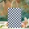 A Navy Blue And White Checkered Gift Bag With White Handles.
