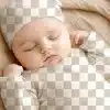 Sleeping Baby Wearing A Hat And Onesie.