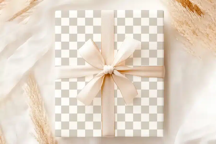A Beige Gift Box With A Beige Ribbon Tied In A Bow.