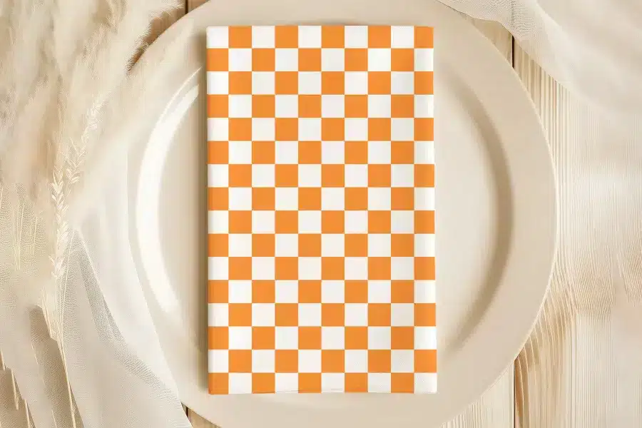 Orange And White Checkered Napkin On A Beige Plate.
