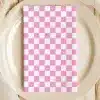 Pink And White Checkered Napkin On A Beige Plate.