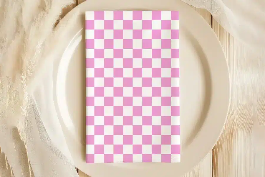 Pink And White Checkered Napkin On A Beige Plate.