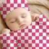 Sleeping Baby Wearing A Pink And White Checkered Hat And Outfit.