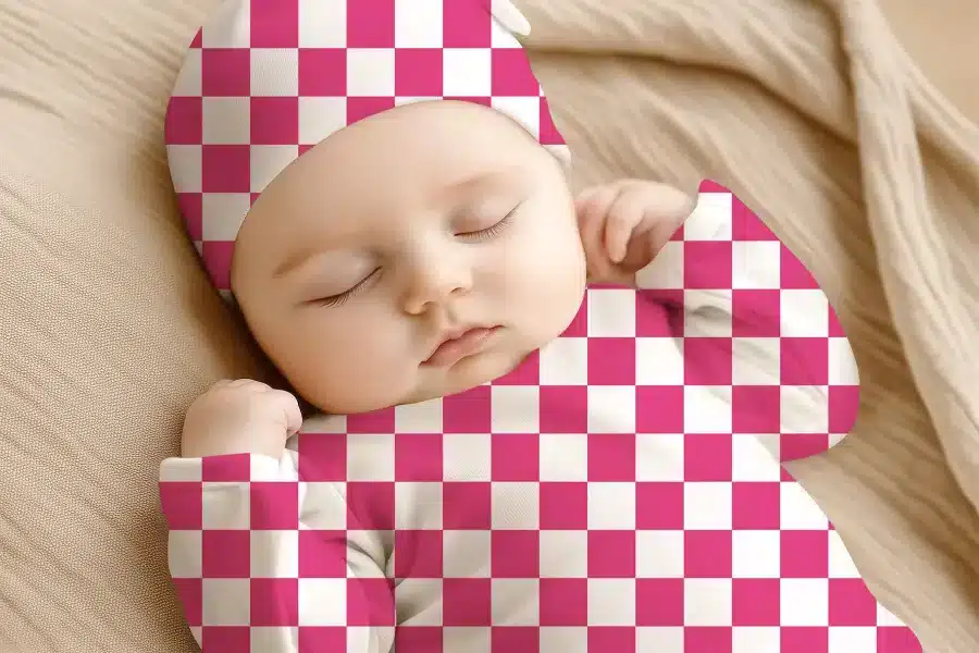 Sleeping Baby Wearing A Pink And White Checkered Hat And Outfit.