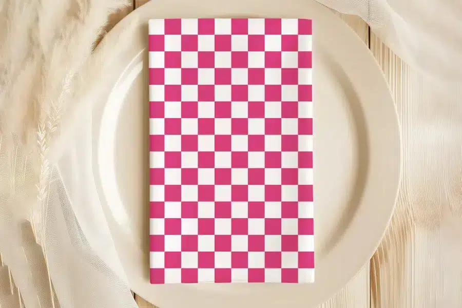 Pink And White Checkered Napkin On A Beige Plate.