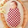Sleeping Baby Swaddled In A Red And White Checkered Receiving Blanket.