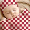 Sleeping Baby Wearing A Red And White Checkered Onesie And Hat.
