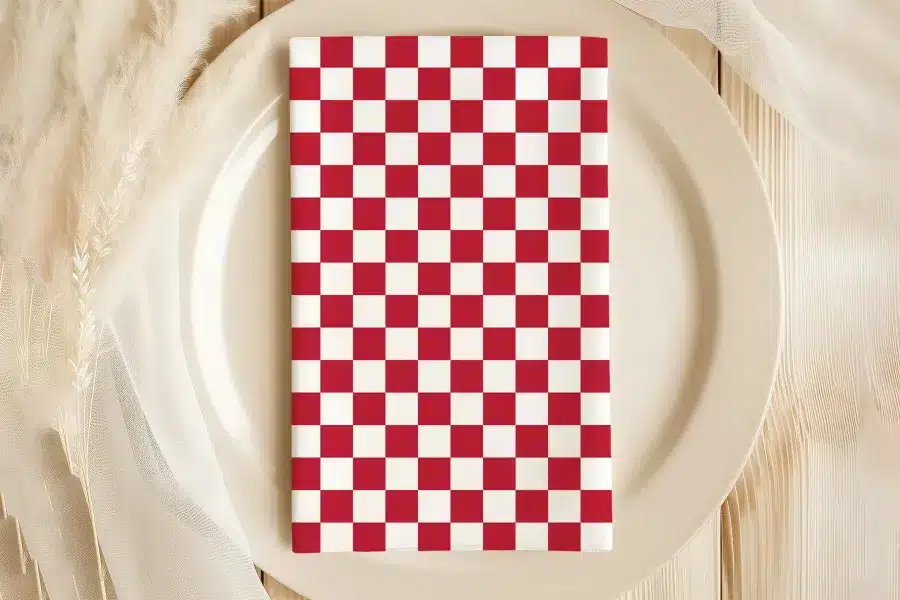 Red And White Checkered Napkin On A Plate.