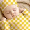 Sleeping Baby Wearing A Yellow And White Checkered Hat And Outfit.