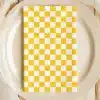 Yellow And White Checkered Napkin On A Beige Plate.