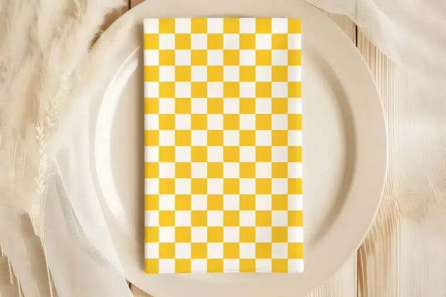 Yellow And White Checkered Napkin On A Beige Plate.