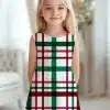 Girl Wearing A Sleeveless White Dress With A Green, Burgundy And Black Plaid Pattern.