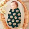 Sleeping Baby Swaddled In A Teal Cinnamon Roll Patterned Wrap.