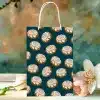 Gift Bag With A Teal Background And A Repeating Pattern Of Cinnamon Rolls.