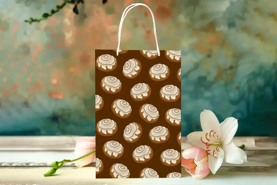 Paper Gift Bag With A Repeating Pattern Of Cinnamon Rolls.