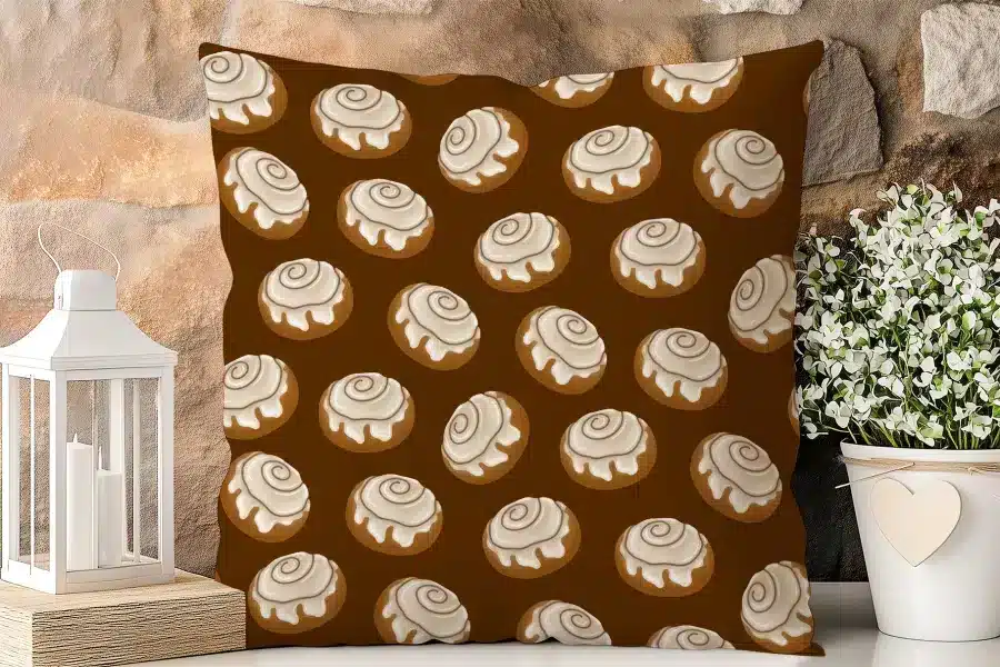 Brown Square Pillow With A Repeating Pattern Of Cinnamon Rolls.