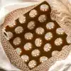 A Roll Of Brown Wrapping Paper With A Repeating Pattern Of Cinnamon Rolls.