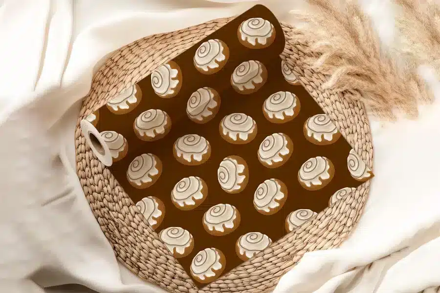 A Roll Of Brown Wrapping Paper With A Repeating Pattern Of Cinnamon Rolls.