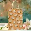 A Tan Paper Gift Bag Decorated With A Pattern Of Cinnamon Rolls.