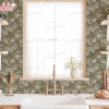Kitchen Sink And Countertop With Floral Wallpaper, Wooden Shelves, And Dishes.