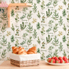 A Wicker Basket Of Croissants Sits On A Kitchen Counter In Front Of A Bowl Of Strawberries.  The Counter Has A Background Of Herb-Themed Wallpaper.