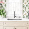 Kitchen Sink And Countertop With Herb-Themed Backsplash, A Plant, And A Wine Bottle.