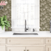 Kitchen Sink With A Plant And Wine Bottle On A Counter.