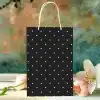Black And White Polka Dot Gift Bag With White Handles.
