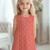 Young Girl In A Coral Polka Dot Dress.