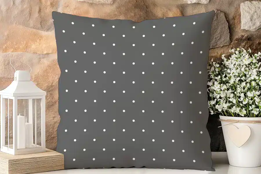 Dark Gray Square Pillow With A White Polka Dot Pattern.