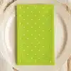 Lime Green Napkin With White Polka Dots On A Beige Plate.