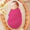 Sleeping Baby Swaddled In A Pink Polka Dot Wrap.