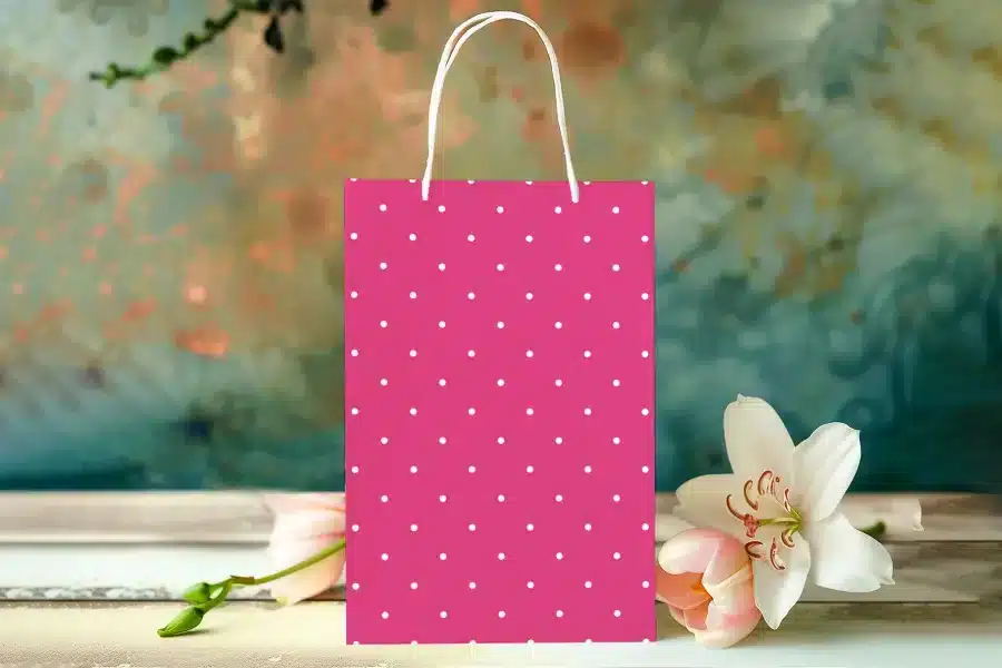 Pink Polka Dot Shopping Bag With White Handles.