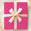 Pink Gift Box With White Polka Dots And A Beige Ribbon.