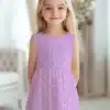 A Young Girl Wearing A Lavender Sleeveless Dress With White Polka Dots.