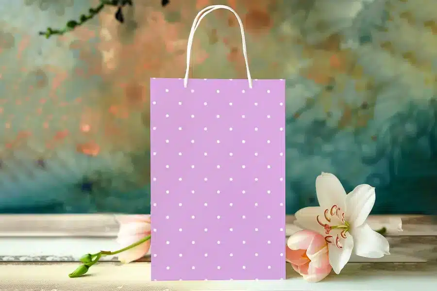 Lavender Gift Bag With White Polka Dots, Near Pink Flowers.