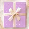 Lavender Gift Box With White Polka Dots And A Beige Ribbon.
