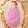 Sleeping Baby Swaddled In A Pink Polka Dot Blanket.