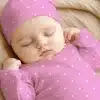 Sleeping Baby Wearing A Pink Polka Dot Hat And Outfit.